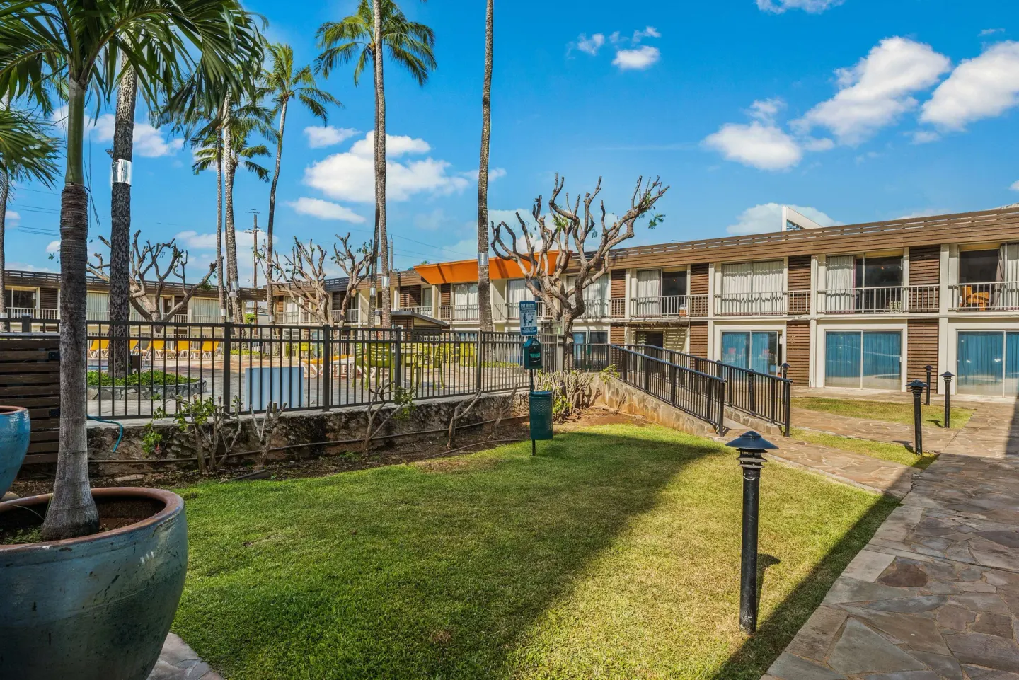 Courtyard lawn and walkways near guest rooms at Best Western The Plaza Hotel Honolulu Airport.