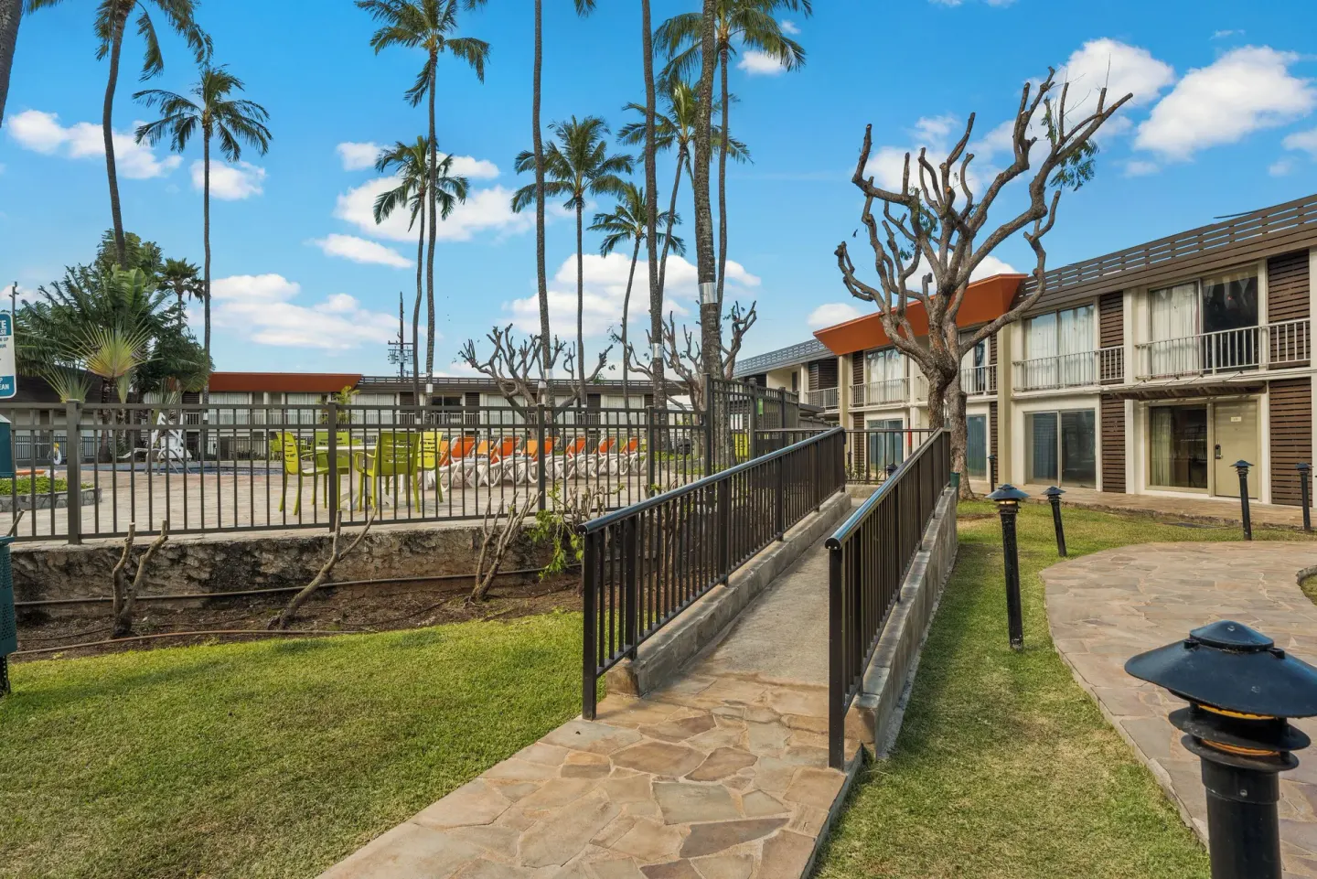 Courtyard walkway and fenced pool area at Best Western The Plaza Hotel Honolulu Airport.