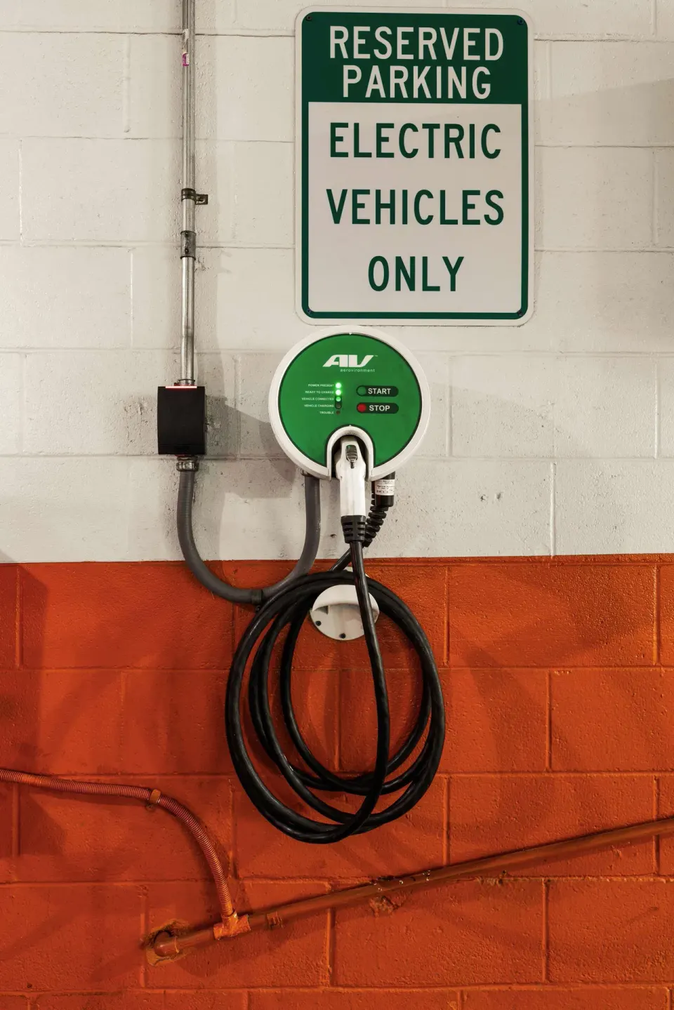 Electric vehicle charging station and reserved parking sign at Best Western The Plaza Hotel Honolulu Airport.