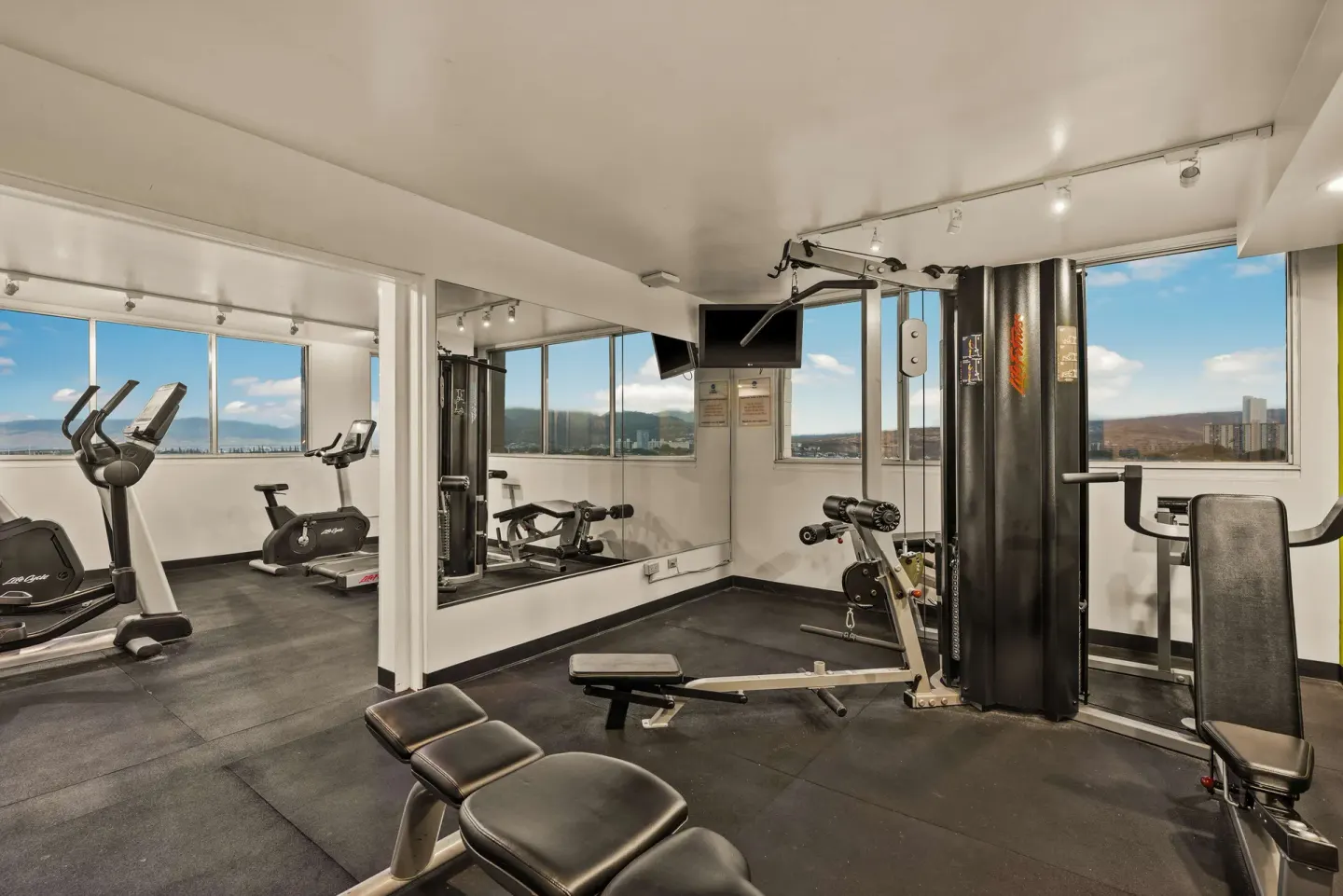 Fitness room with cardio and weight equipment at Best Western The Plaza Hotel Honolulu Airport.