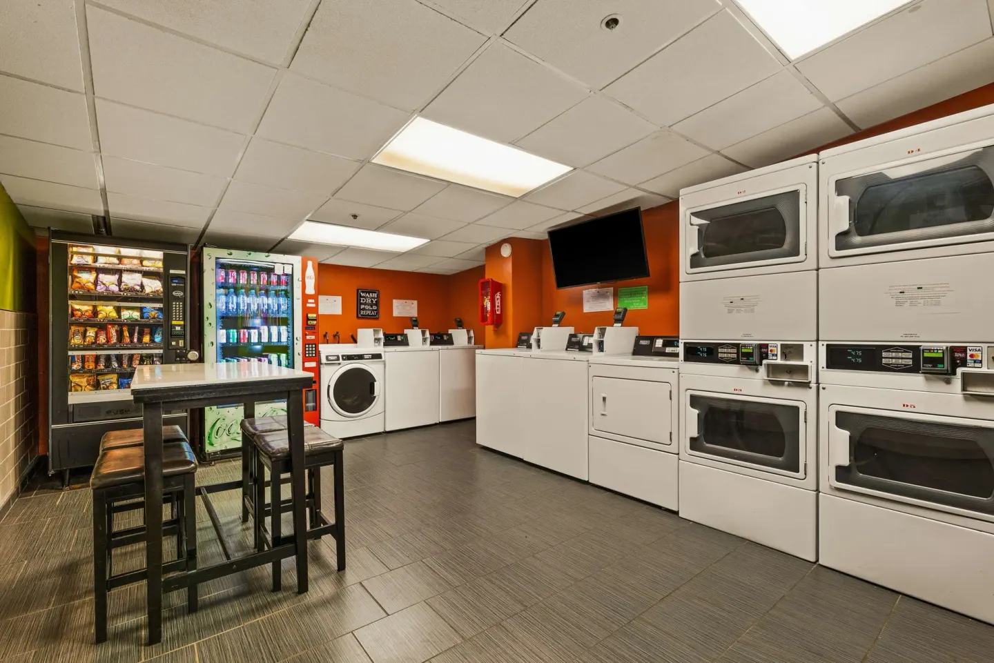 Guest laundry room with washers, dryers, and vending machines at Best Western The Plaza Hotel Honolulu Airport.
