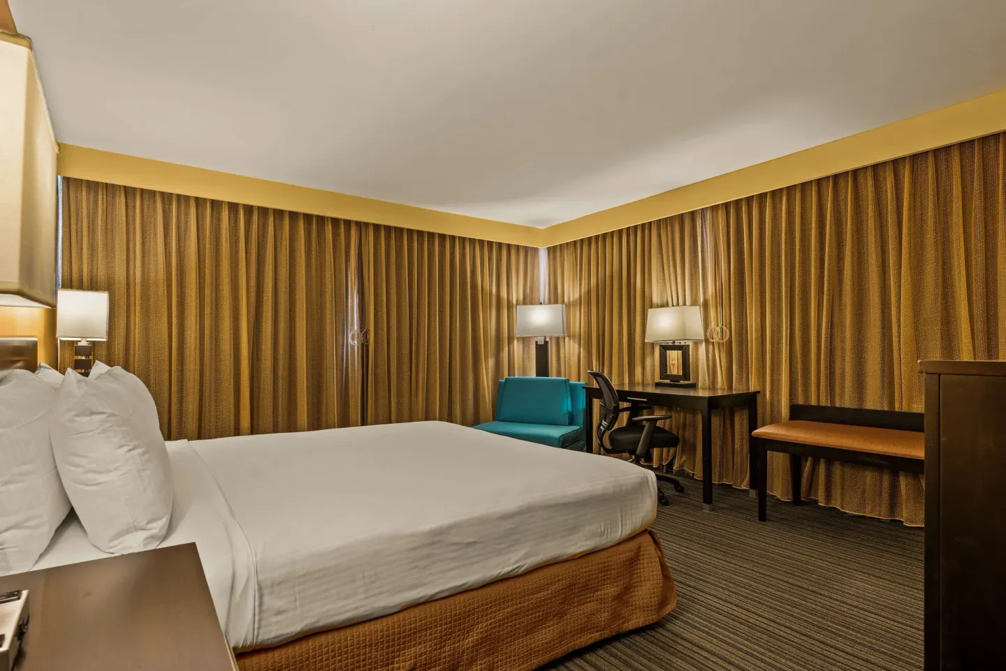 King bed guest room with desk and lounge chair at Best Western The Plaza Hotel Honolulu Airport.