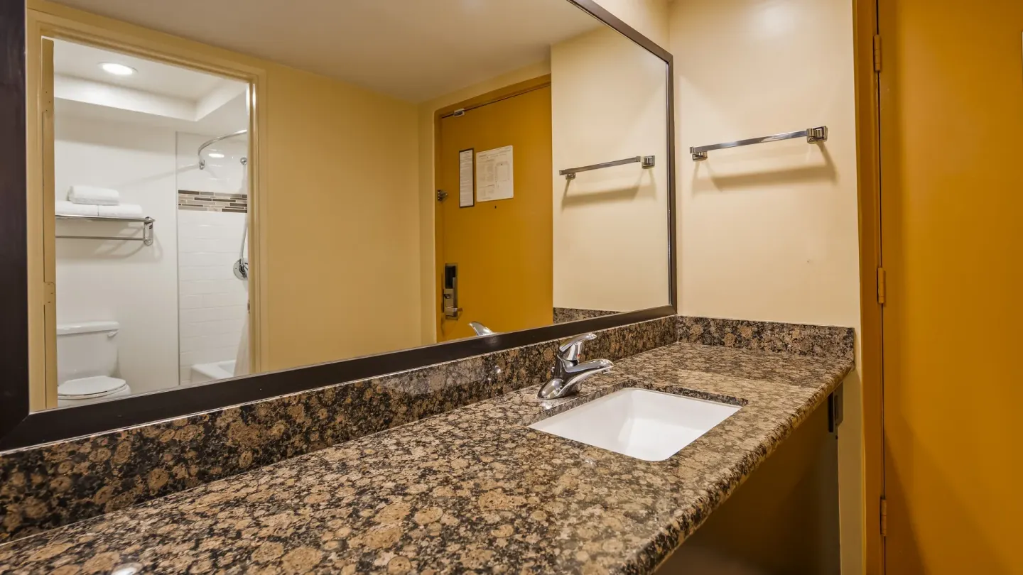 Guest room vanity with granite counter at Best Western The Plaza Hotel Honolulu Airport.