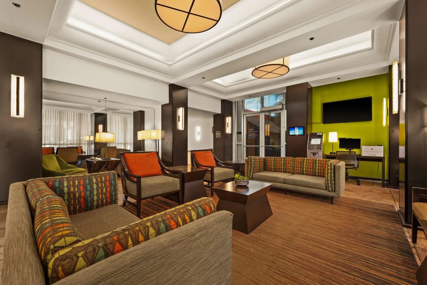 Lobby seating area with patterned sofas at Best Western The Plaza Hotel Honolulu Airport.