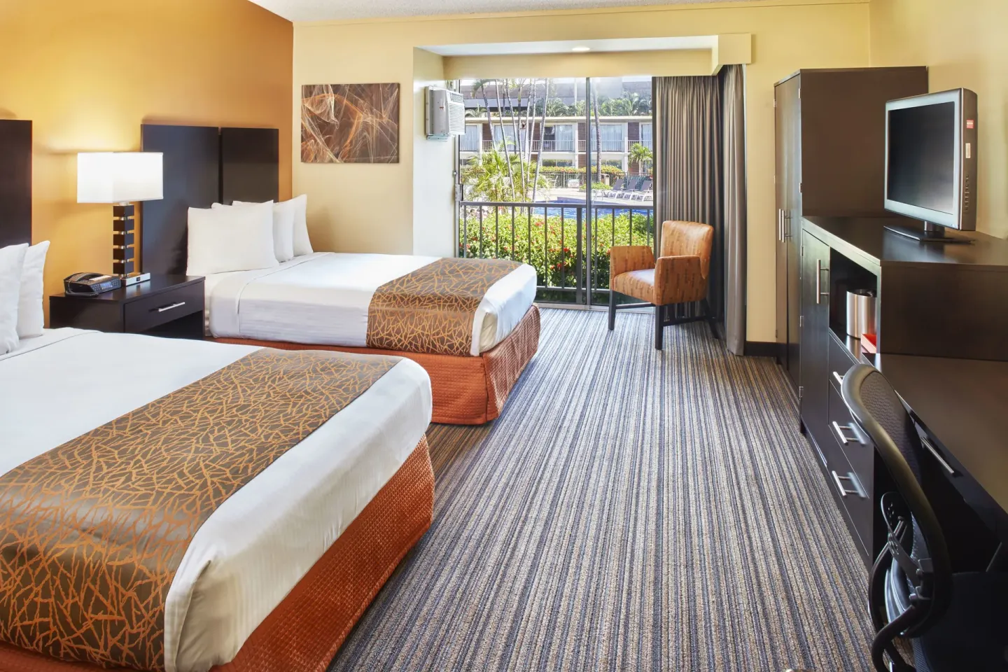 Two-bed guest room with balcony view at Best Western The Plaza Hotel Honolulu Airport.