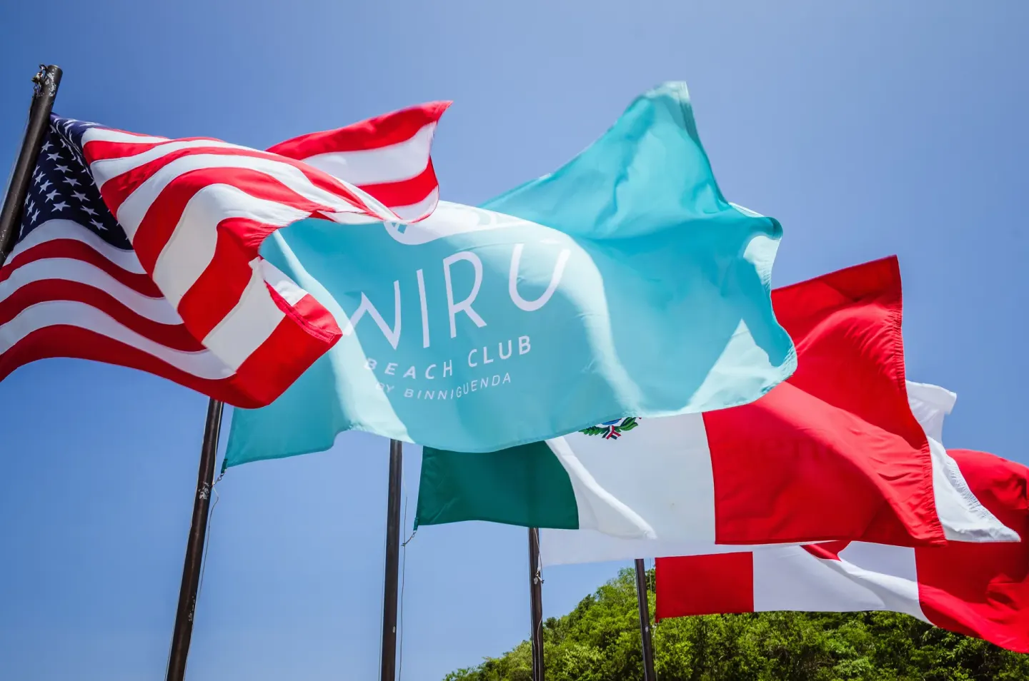 Flags waving at the beach club at Binniguenda Huatulco & Beach Club.