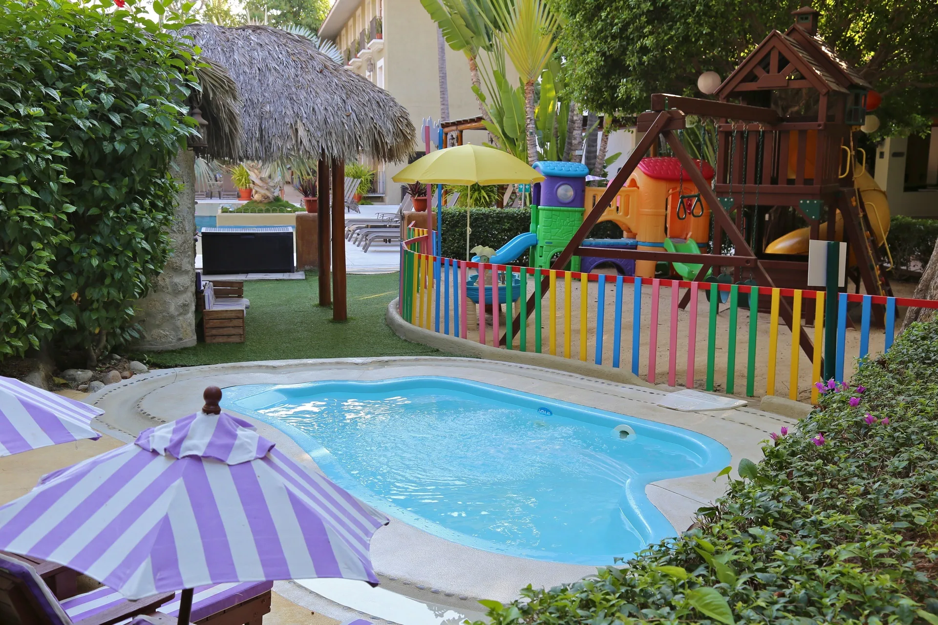 Children's pool and colorful playground at Binniguenda Huatulco & Beach Club.