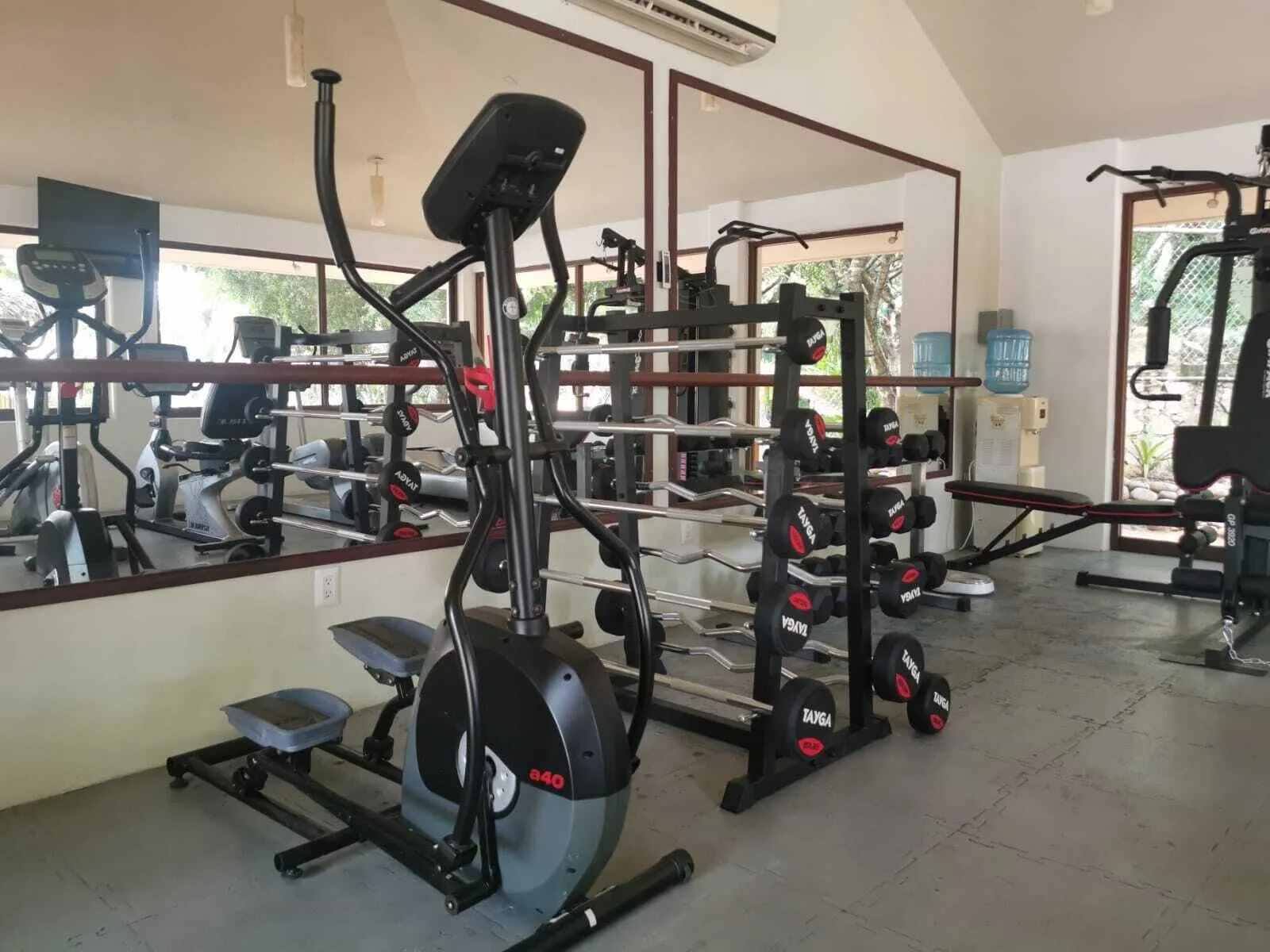 Fitness room with elliptical, weights, and mirrors at Binniguenda Huatulco & Beach Club.