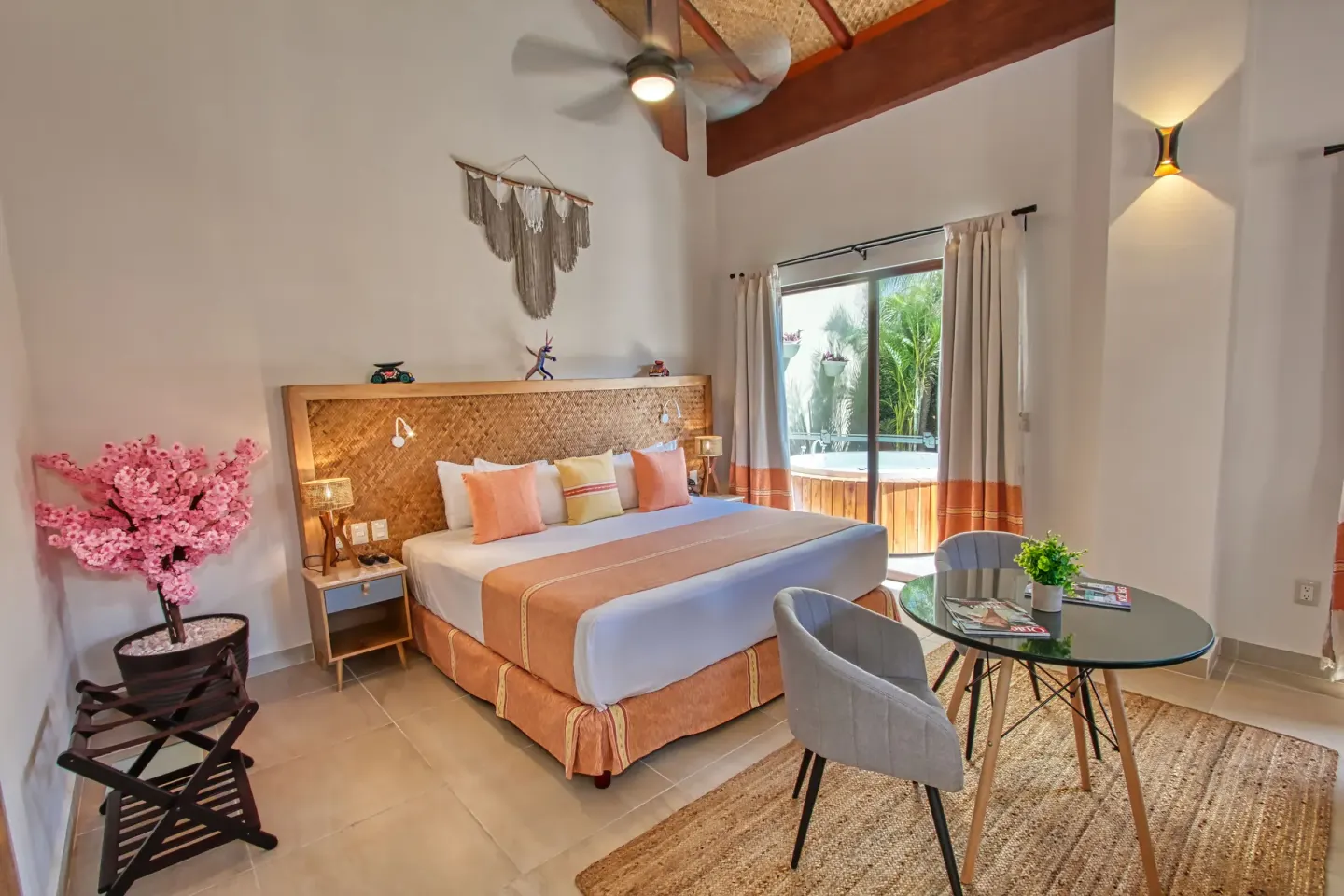 King bed guest room with round table at Binniguenda Huatulco & Beach Club.