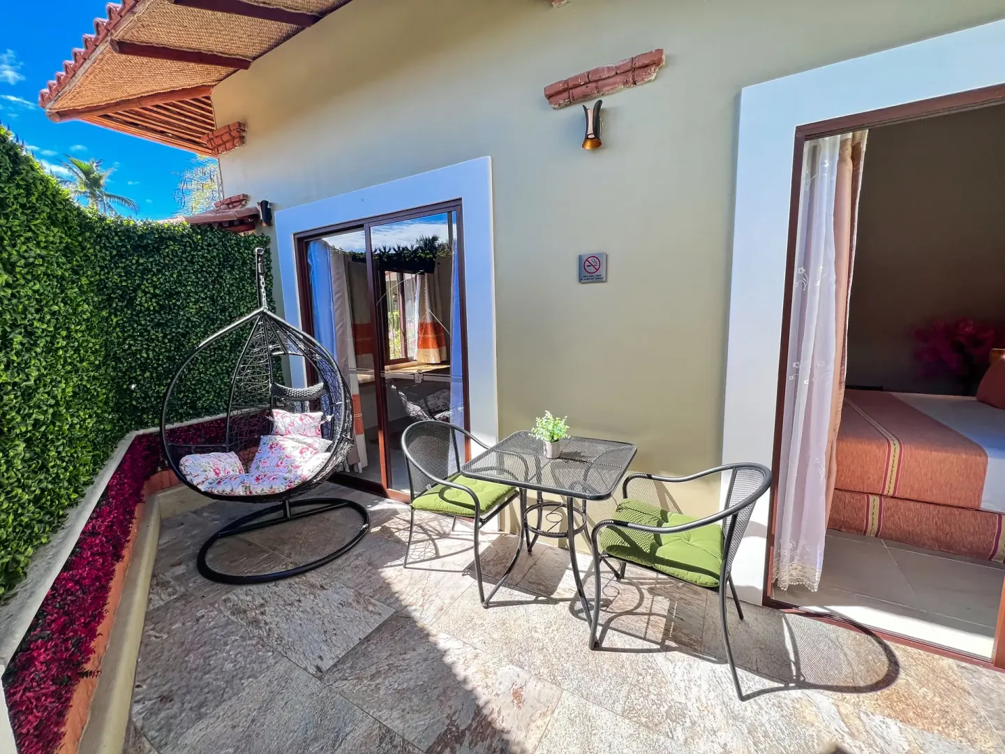 Private patio with hanging chair outside a guest room at Binniguenda Huatulco & Beach Club.
