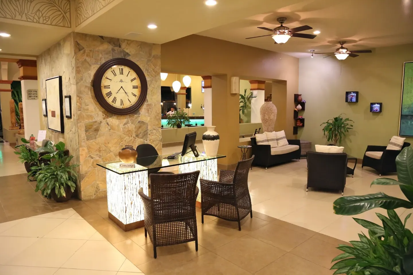 Lobby seating and concierge desk at Binniguenda Huatulco & Beach Club.