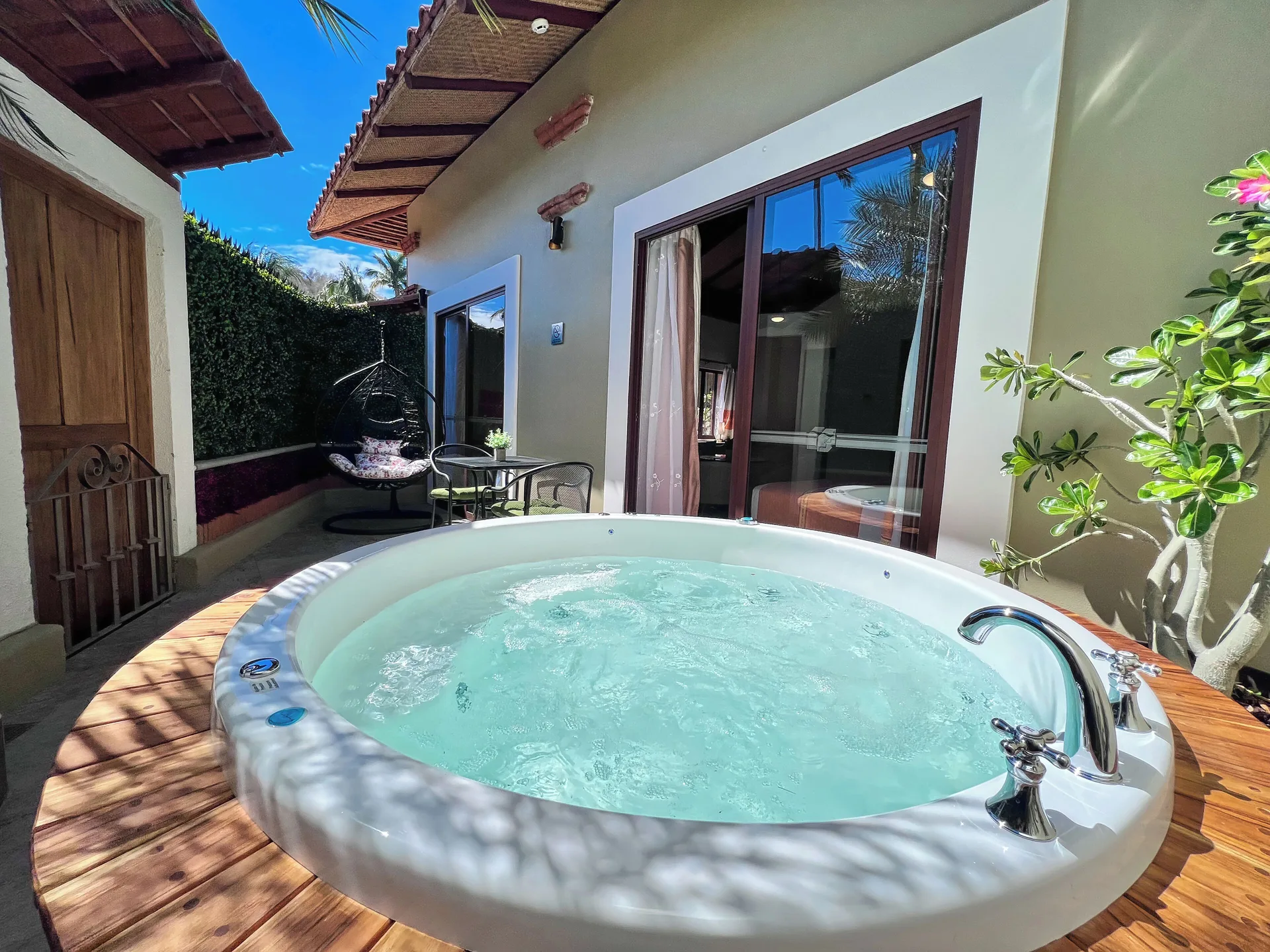 Private terrace whirlpool at Binniguenda Huatulco & Beach Club with seating and sliding glass doors.