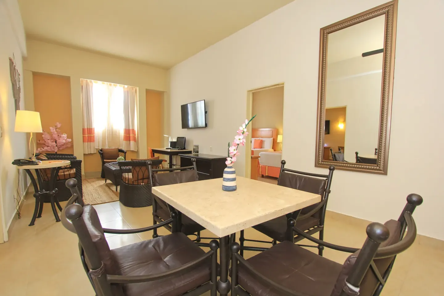 Suite dining table and sitting area at Binniguenda Huatulco & Beach Club.