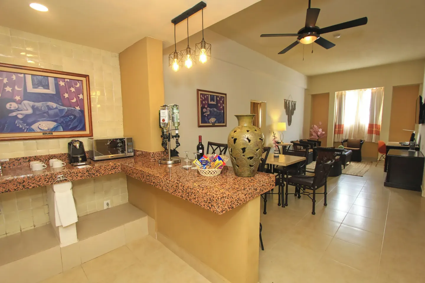 Suite kitchenette and living area at Binniguenda Huatulco & Beach Club with counter seating and lounge space.
