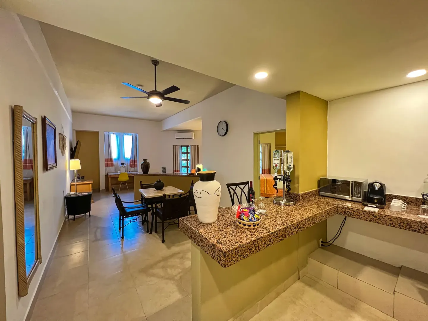 Suite kitchenette with granite counter and dining area at Binniguenda Huatulco & Beach Club.
