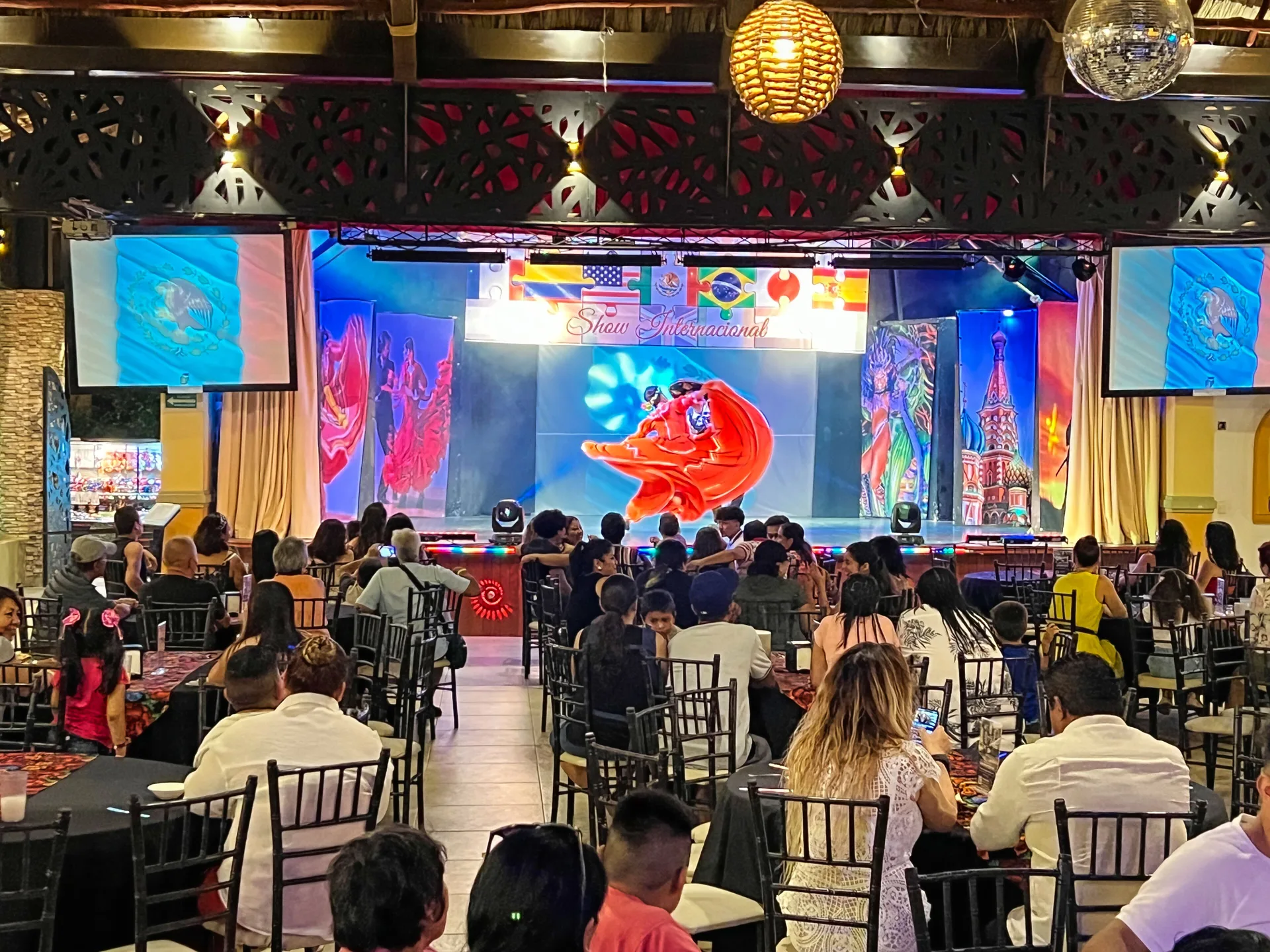 International-themed stage show with seated audience at Binniguenda Huatulco & Beach Club.
