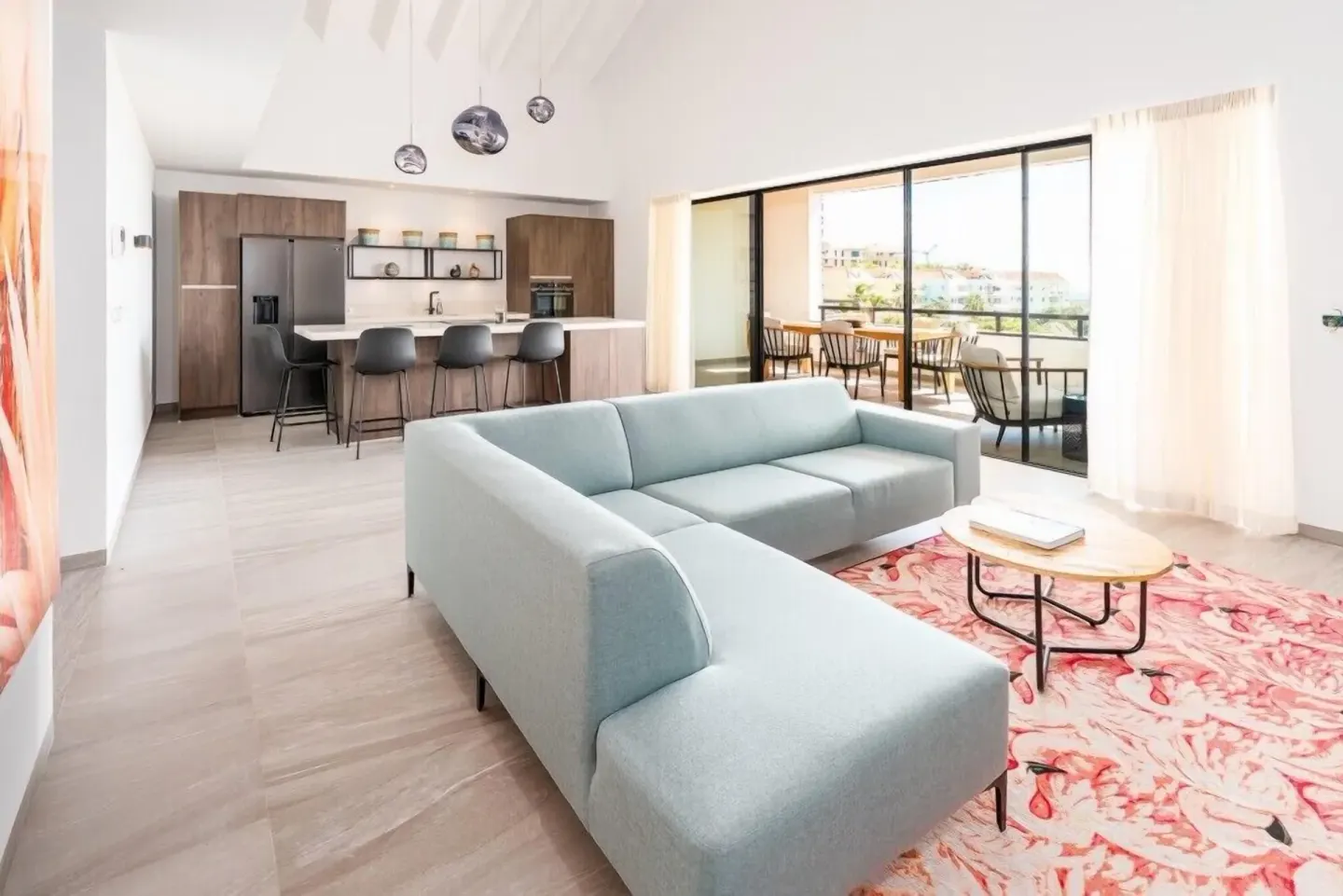 Bright apartment living room with kitchen and balcony at Blue Bay Curacao Golf & Beach Resort.