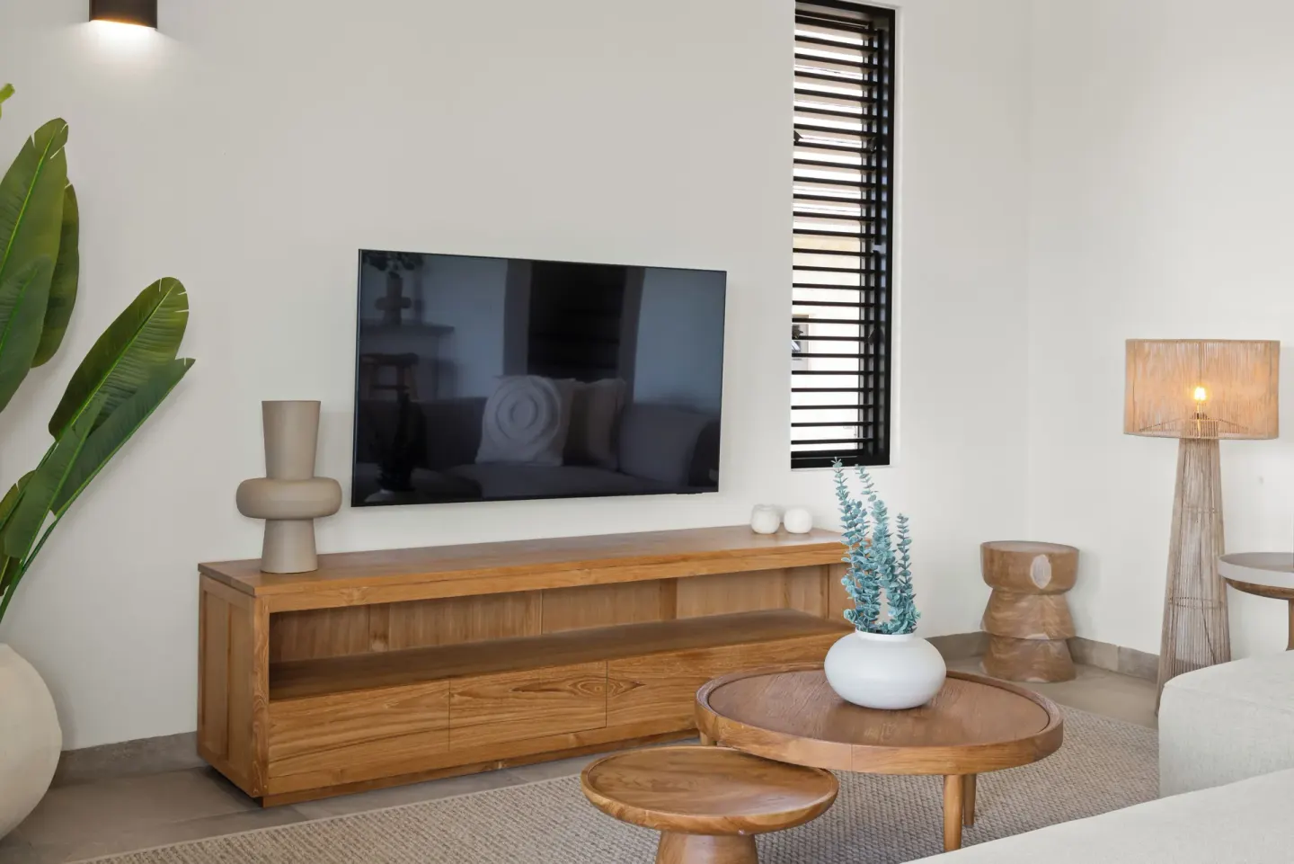 Guest residence sitting area with TV and wood furniture at Blue Bay Curacao Golf & Beach Resort.