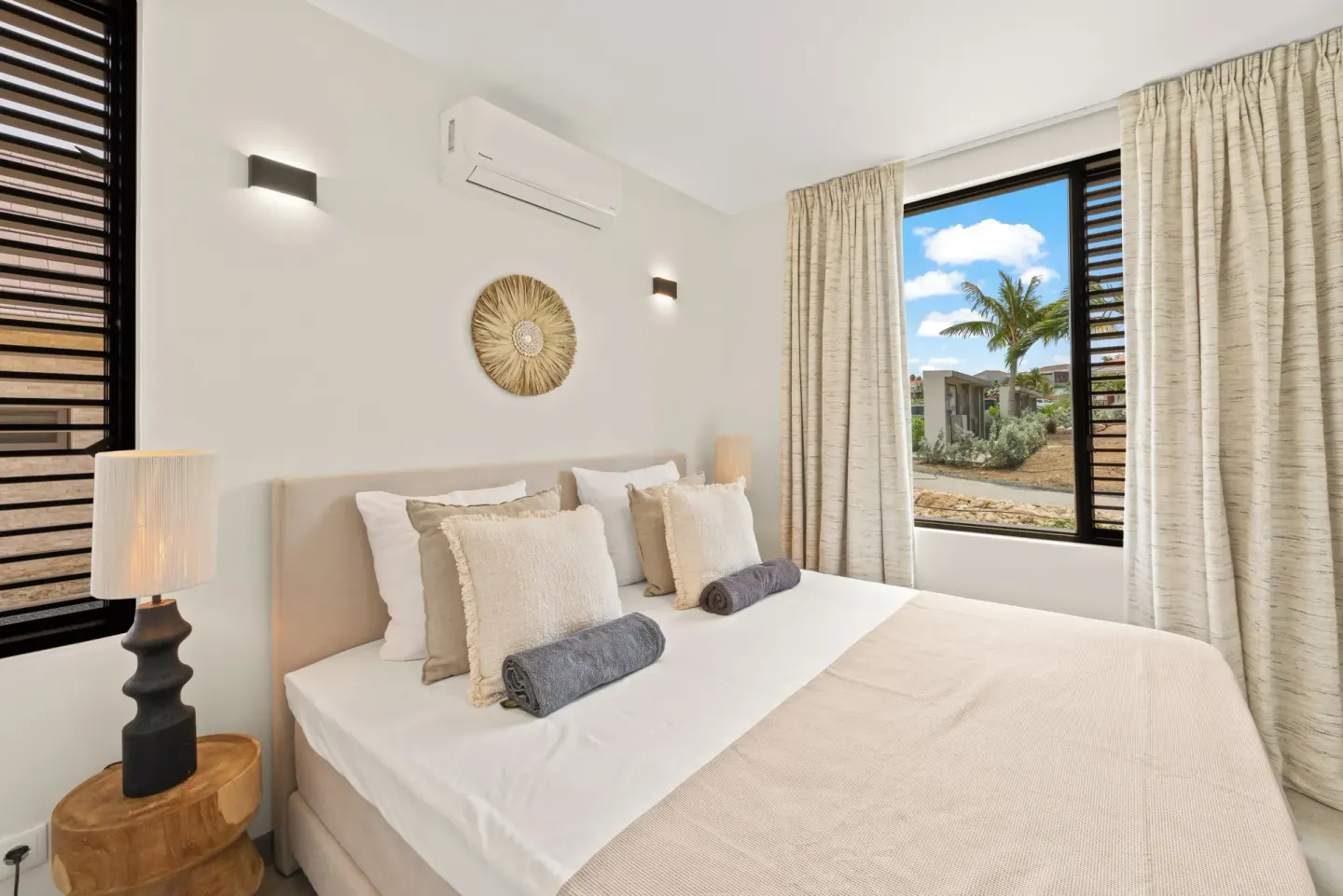 Guest room with king bed and garden-view windows at Blue Bay Curacao Golf & Beach Resort.