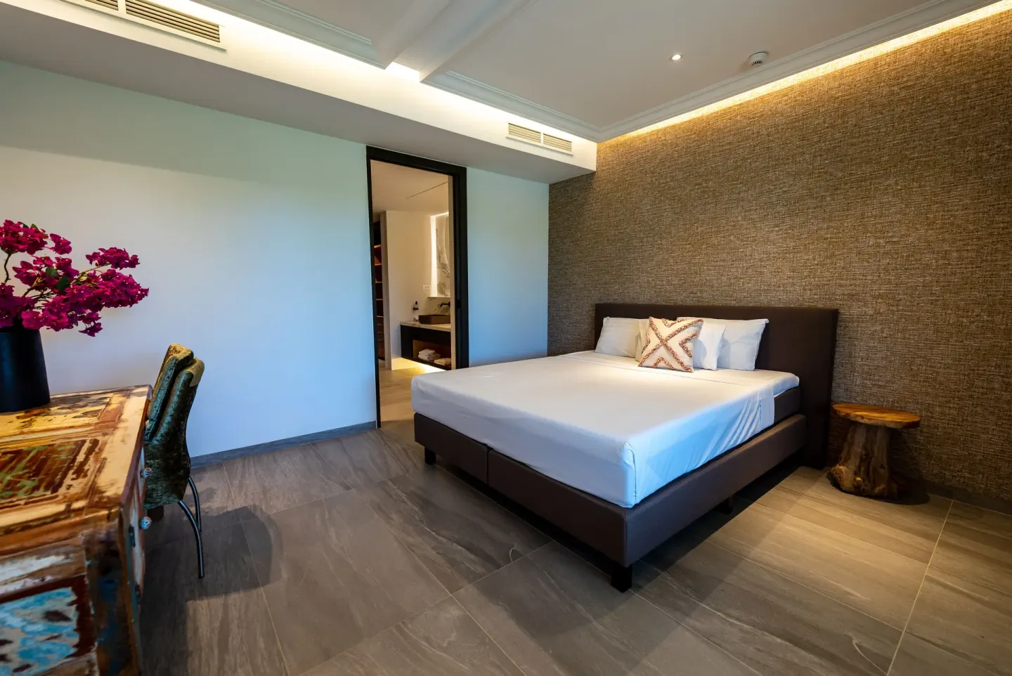 Guest room with king bed and rustic desk at Blue Bay Curacao Golf & Beach Resort.