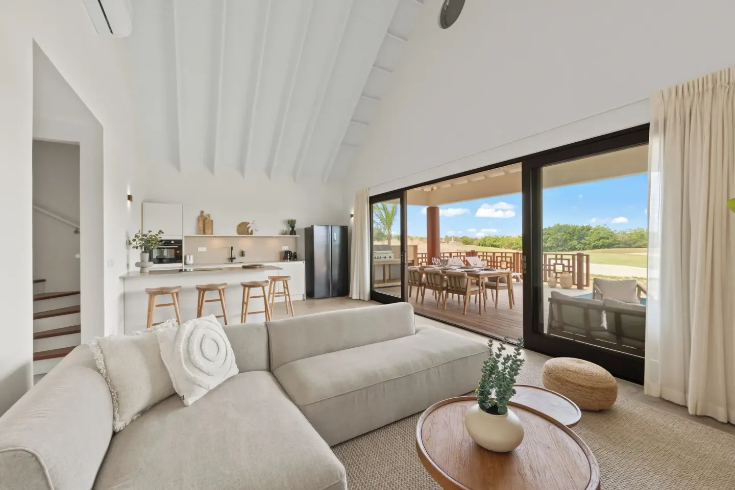 High-ceiling living room opening to a terrace at Blue Bay Curacao Golf & Beach Resort.