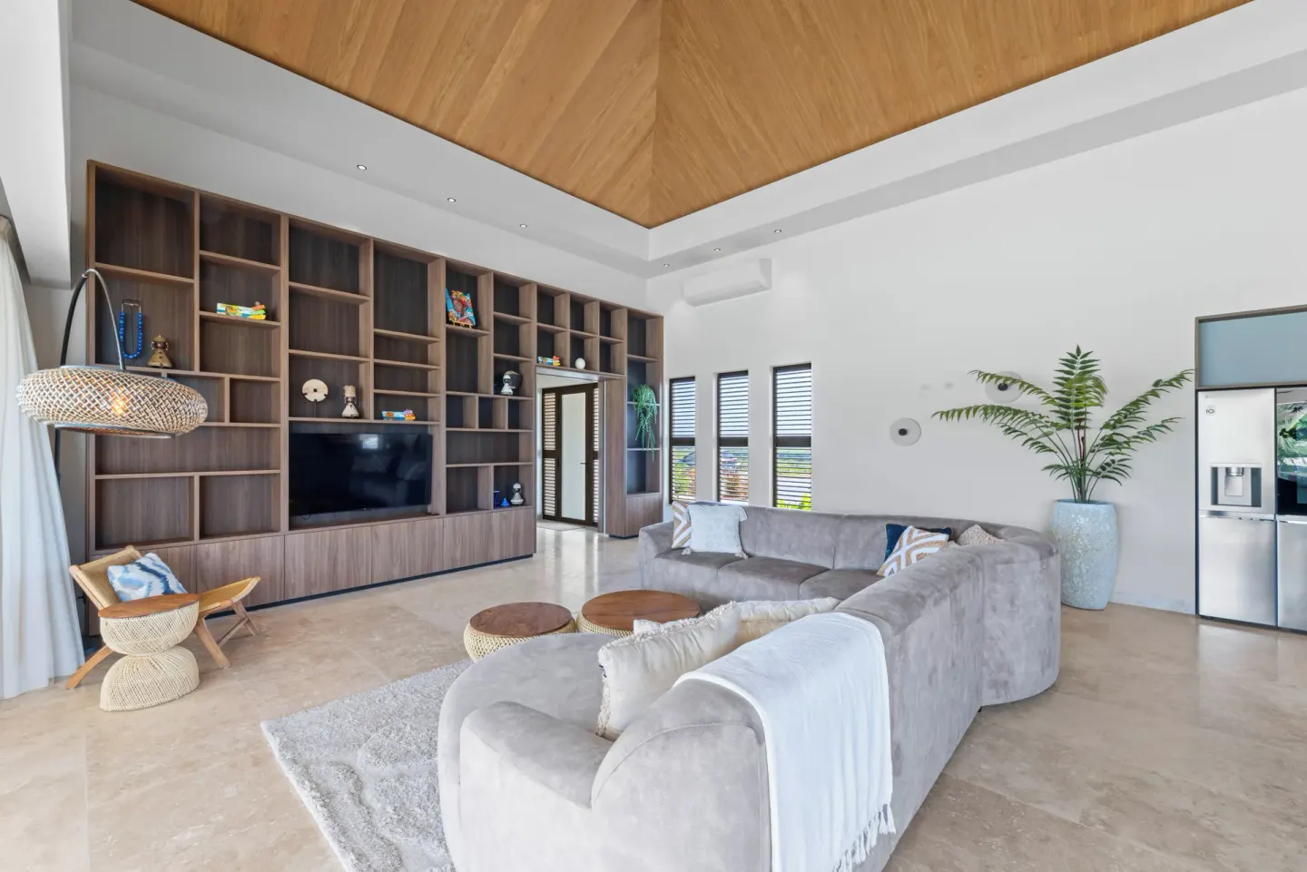 Living room with built-in shelving and gray sectional at Blue Bay Curacao Golf & Beach Resort.