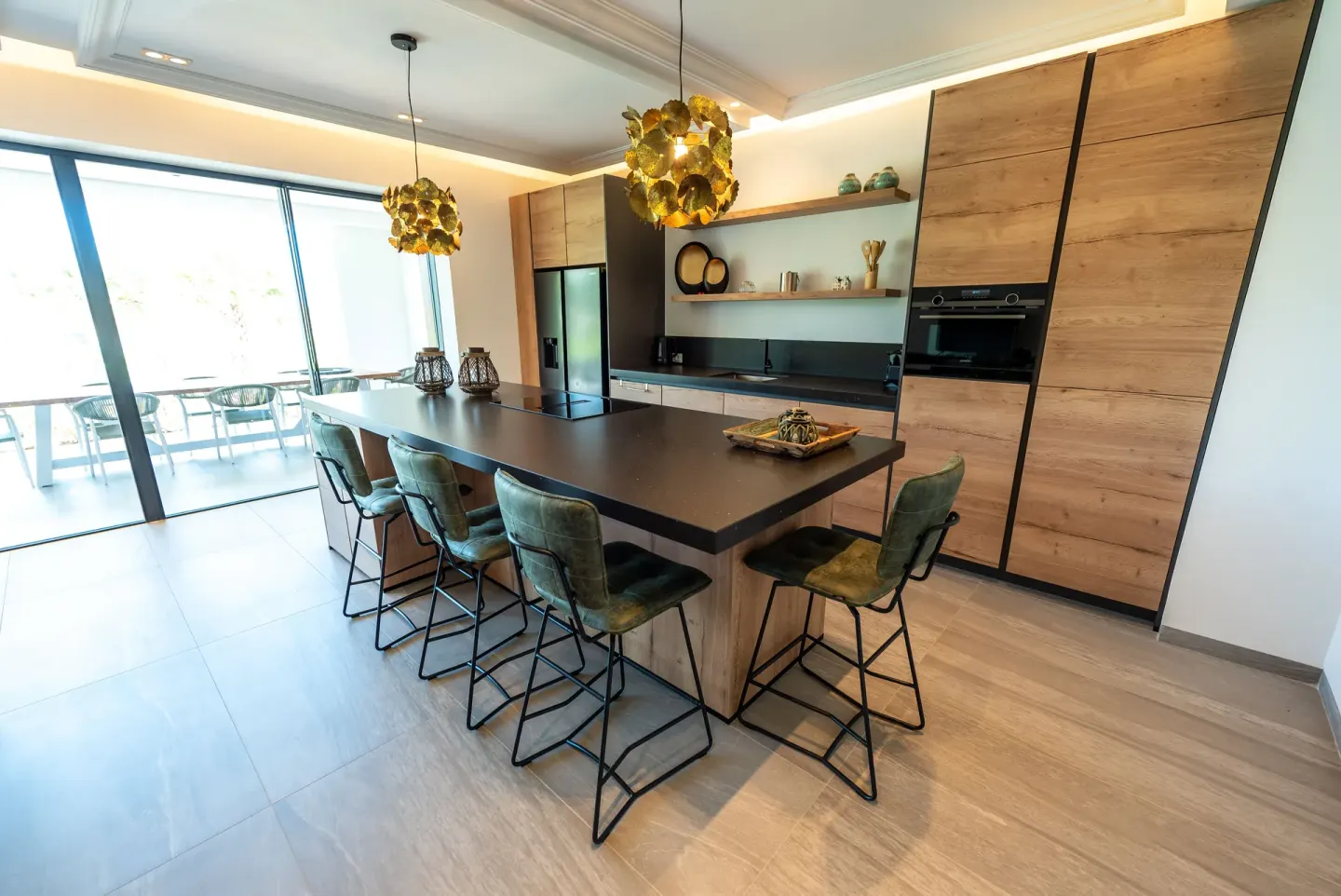 Modern kitchen island with green bar chairs at Blue Bay Curacao Golf & Beach Resort.