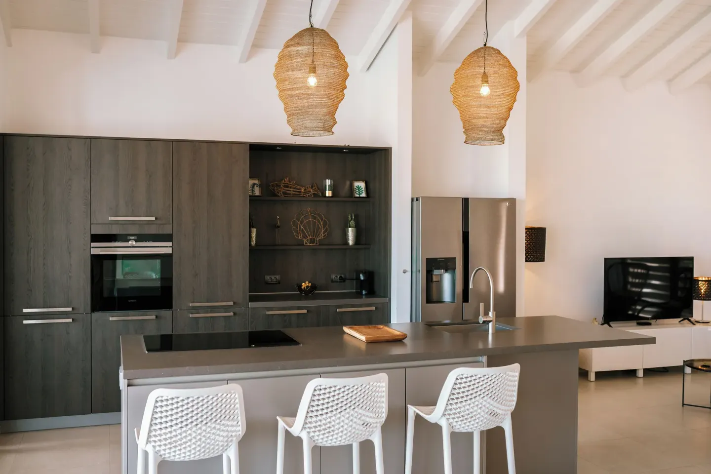 Open living area kitchen with woven pendant lights at Blue Bay Curacao Golf & Beach Resort.