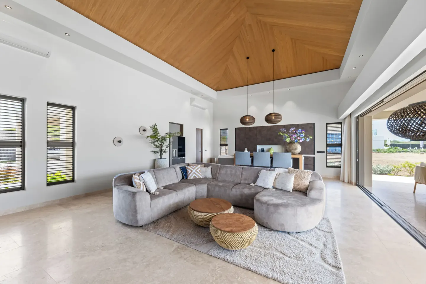 Open lounge with sectional sofa and wood ceiling at Blue Bay Curacao Golf & Beach Resort.