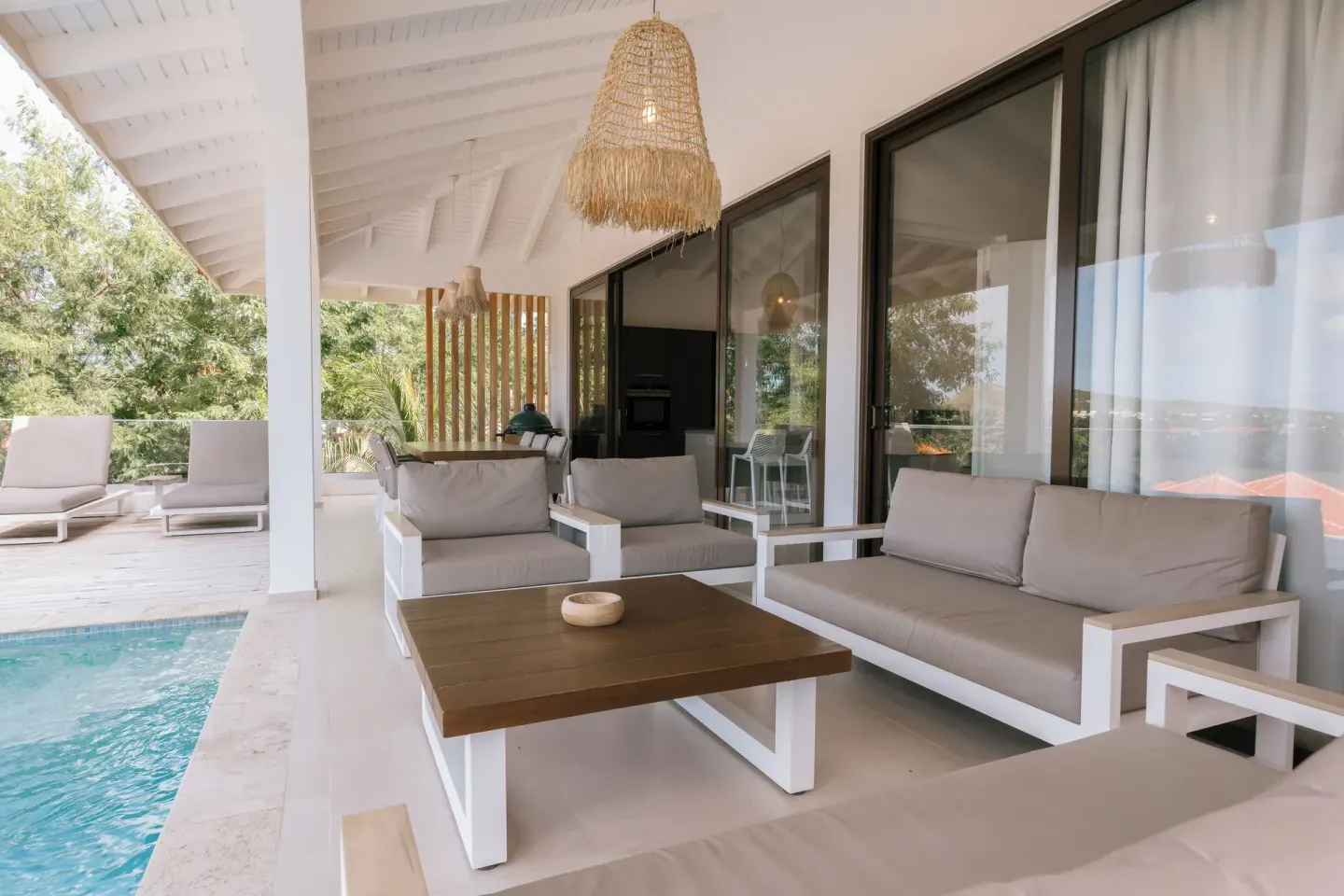 Poolside covered patio with cushioned seating at Blue Bay Curacao Golf & Beach Resort.