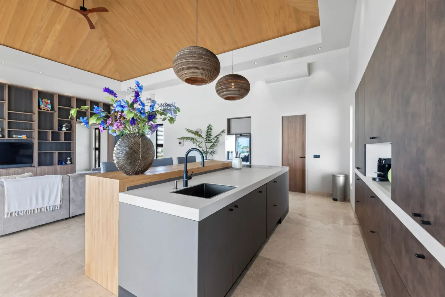 Modern island kitchen and lounge in a villa at Blue Bay Curacao Golf & Beach Resort.