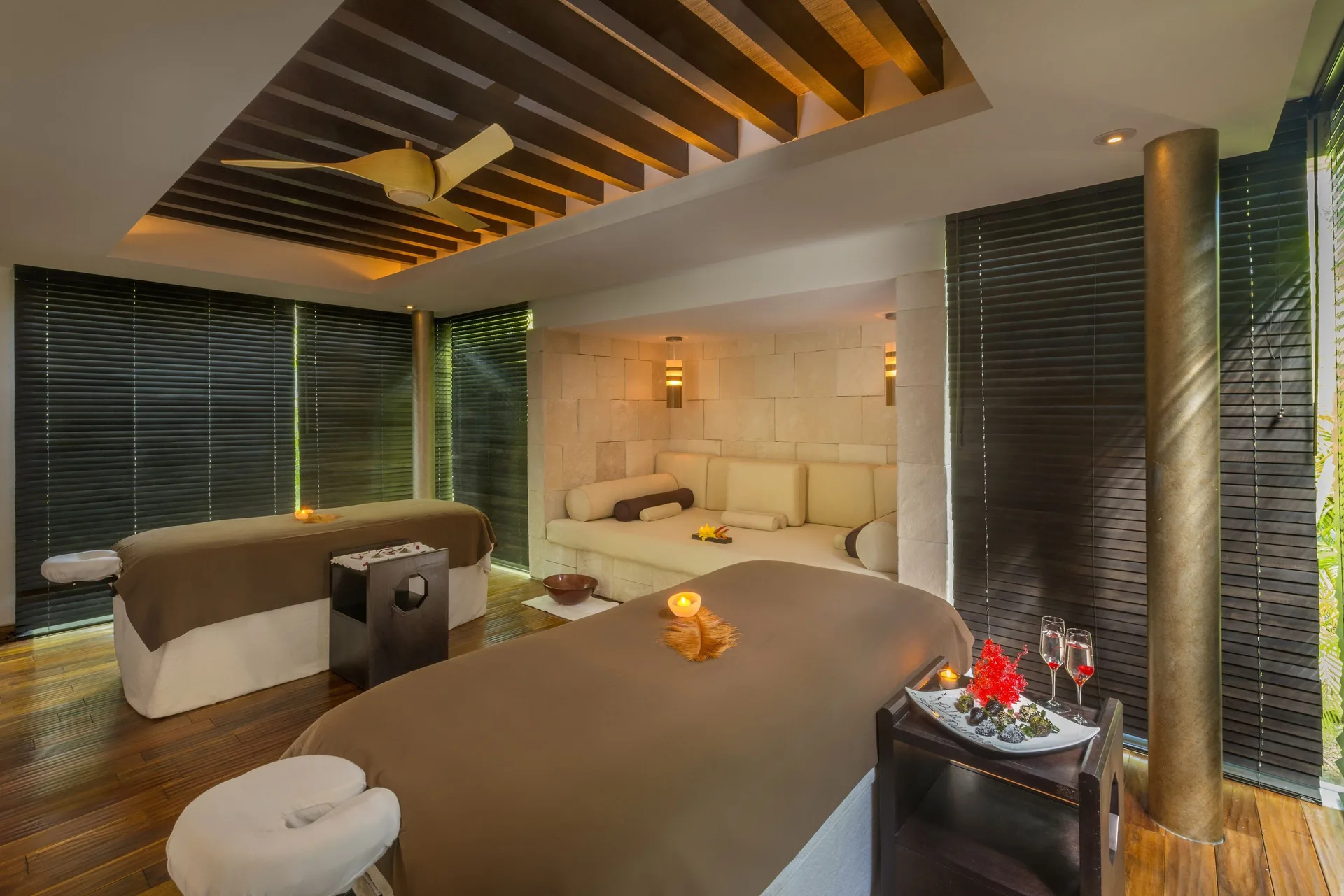 Massage treatment room with two tables and candles at Blue Diamond Luxury Boutique.