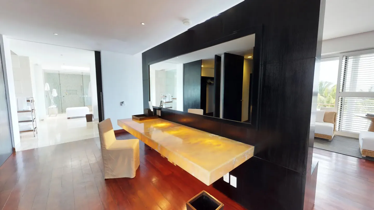 Suite dressing counter with large mirror and seating at Blue Diamond Luxury Boutique.