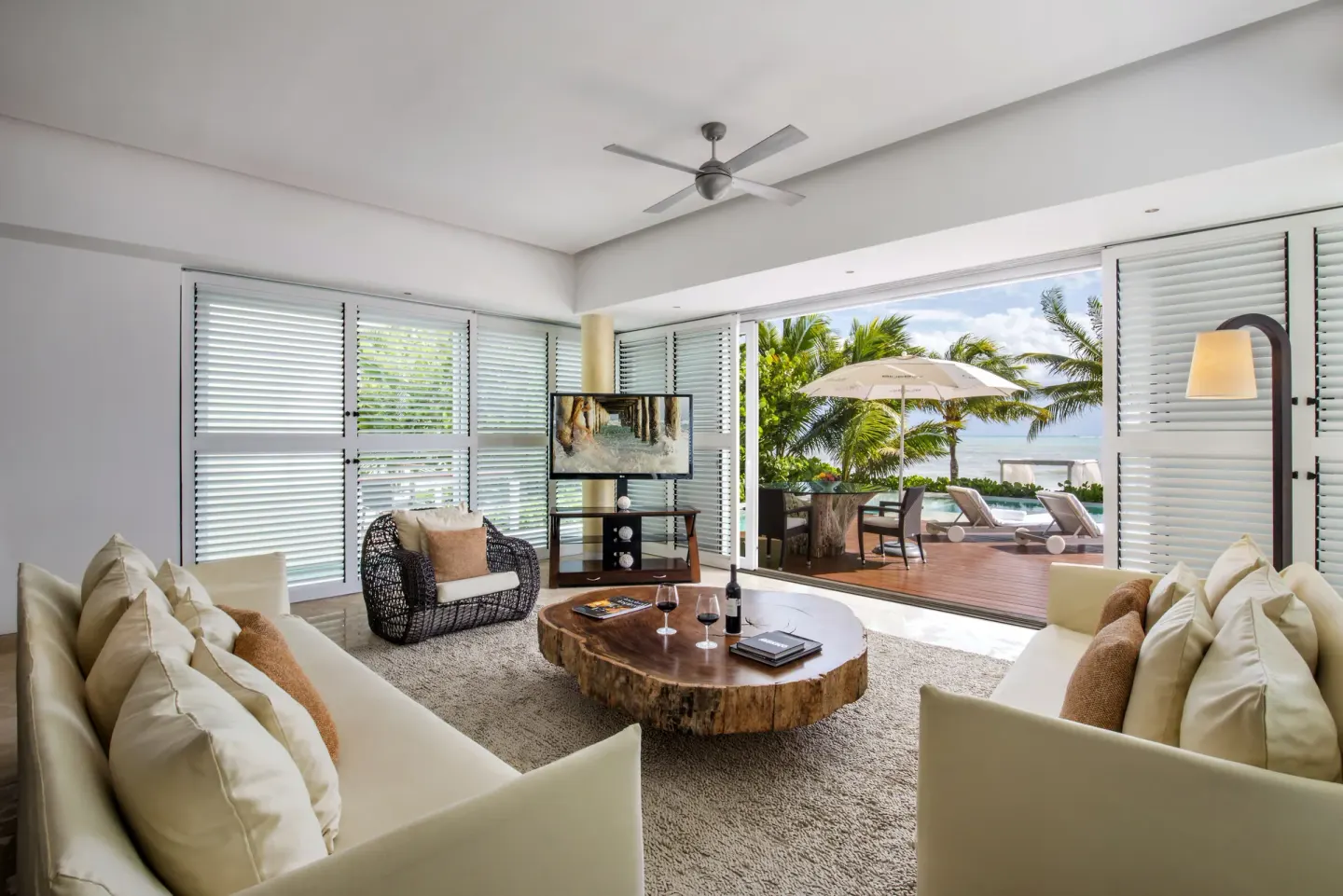 Living room with sofas opening to a terrace and plunge pool at Blue Diamond Luxury Boutique.