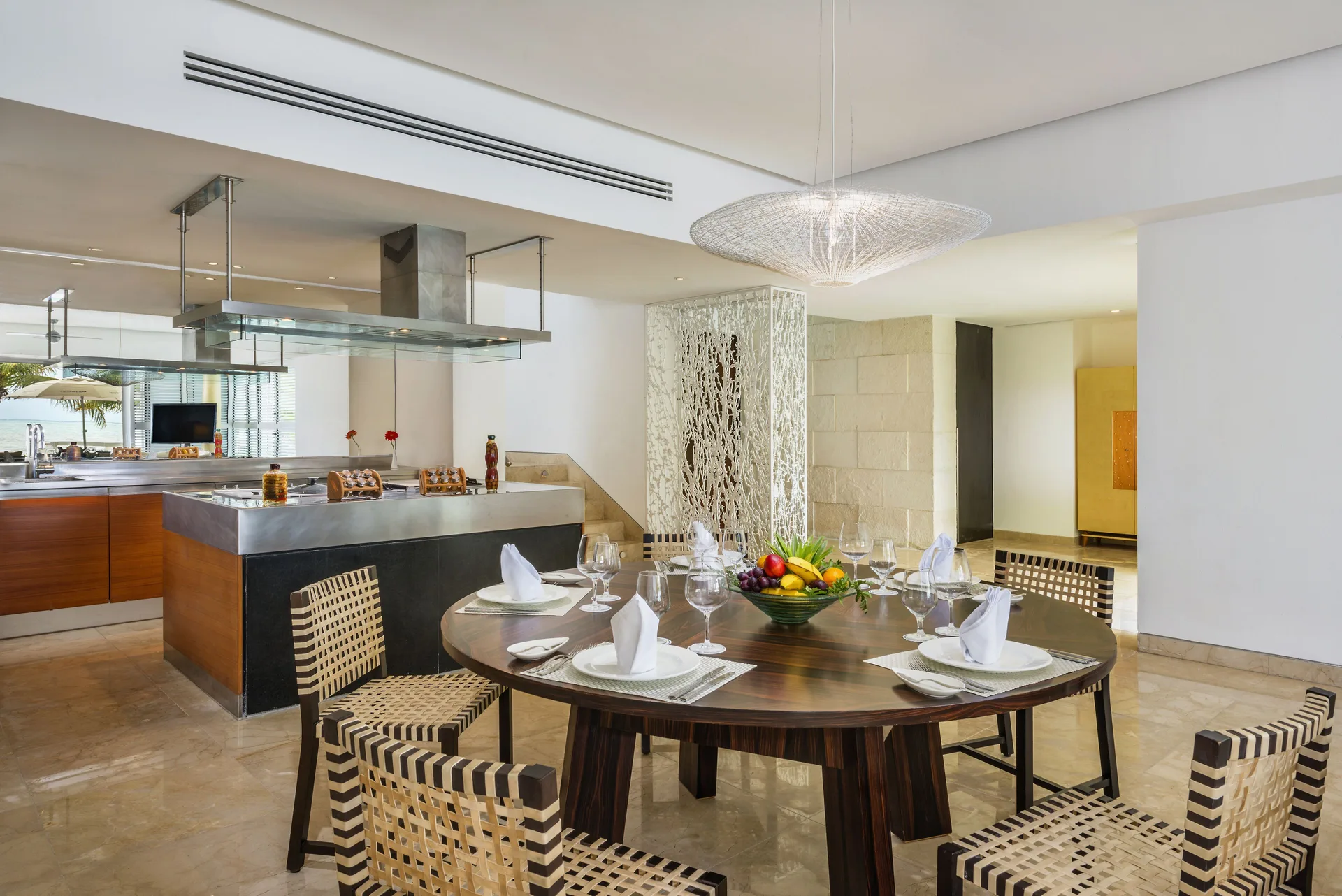 Dining table and open kitchen in a suite at Blue Diamond Luxury Boutique.