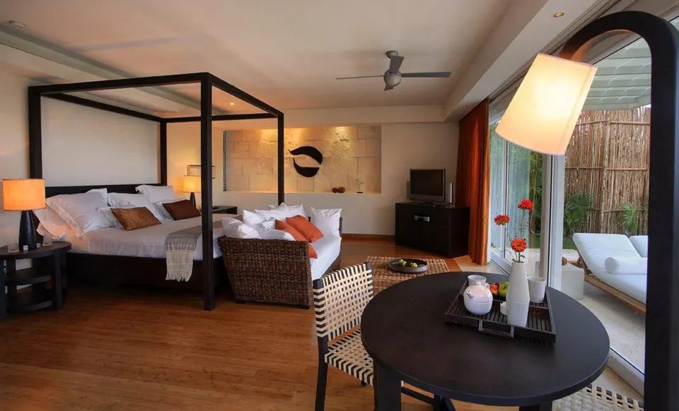 Cenote Lagoon Deluxe Junior Suite king bed and sitting area at Blue Diamond Luxury Boutique.