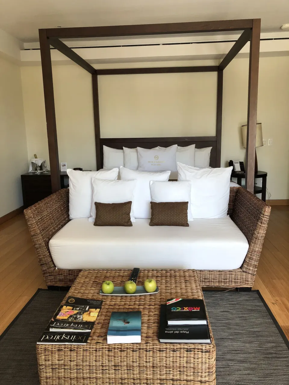 Cenote Lagoon Deluxe Junior Suite king bed behind a white sofa at Blue Diamond Luxury Boutique.