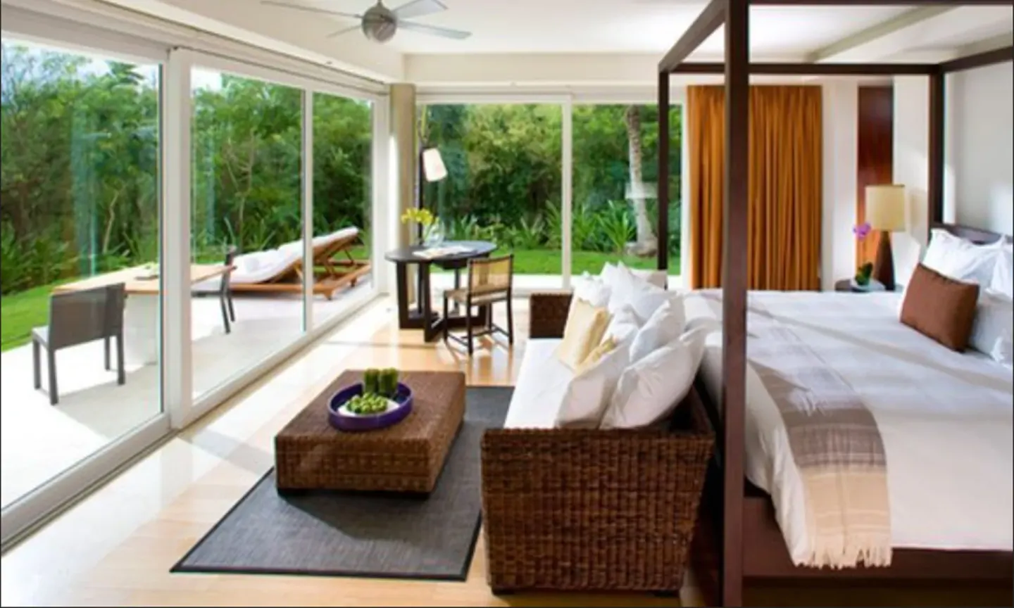 Cenote Lagoon Deluxe Junior Suite king bed and terrace at Blue Diamond Luxury Boutique.