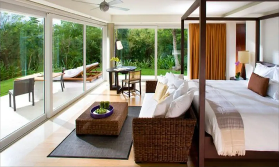 Cenote Lagoon Deluxe Junior Suite king bed and terrace at Blue Diamond Luxury Boutique.