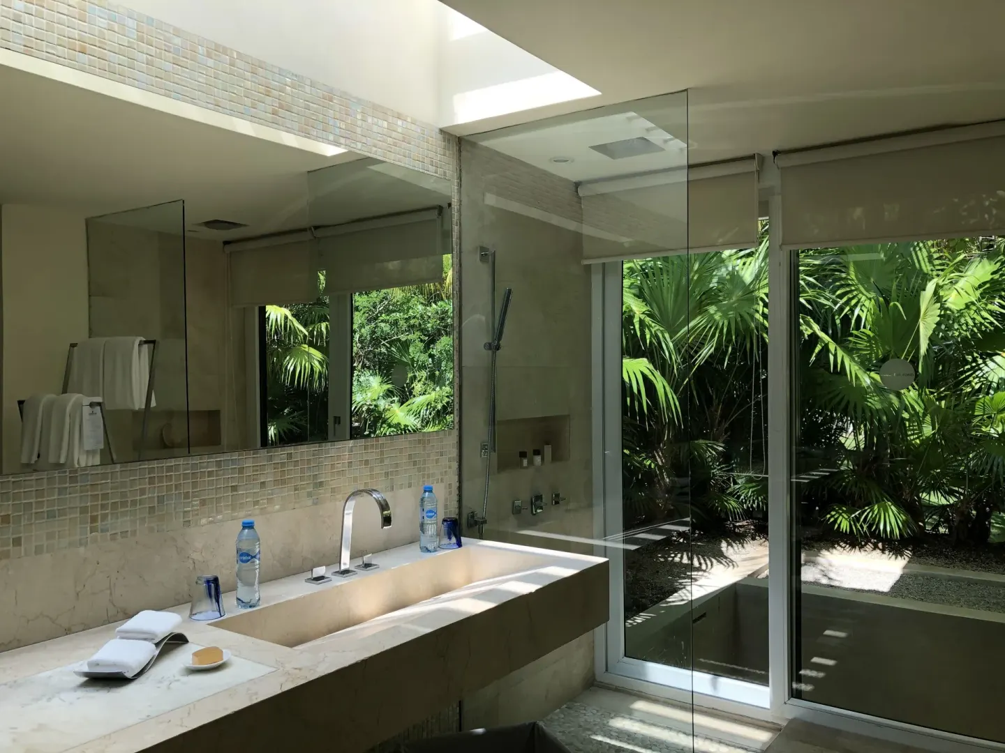 Junior Suite Patio bathroom with long sink, shower, and garden view at Blue Diamond Luxury Boutique.