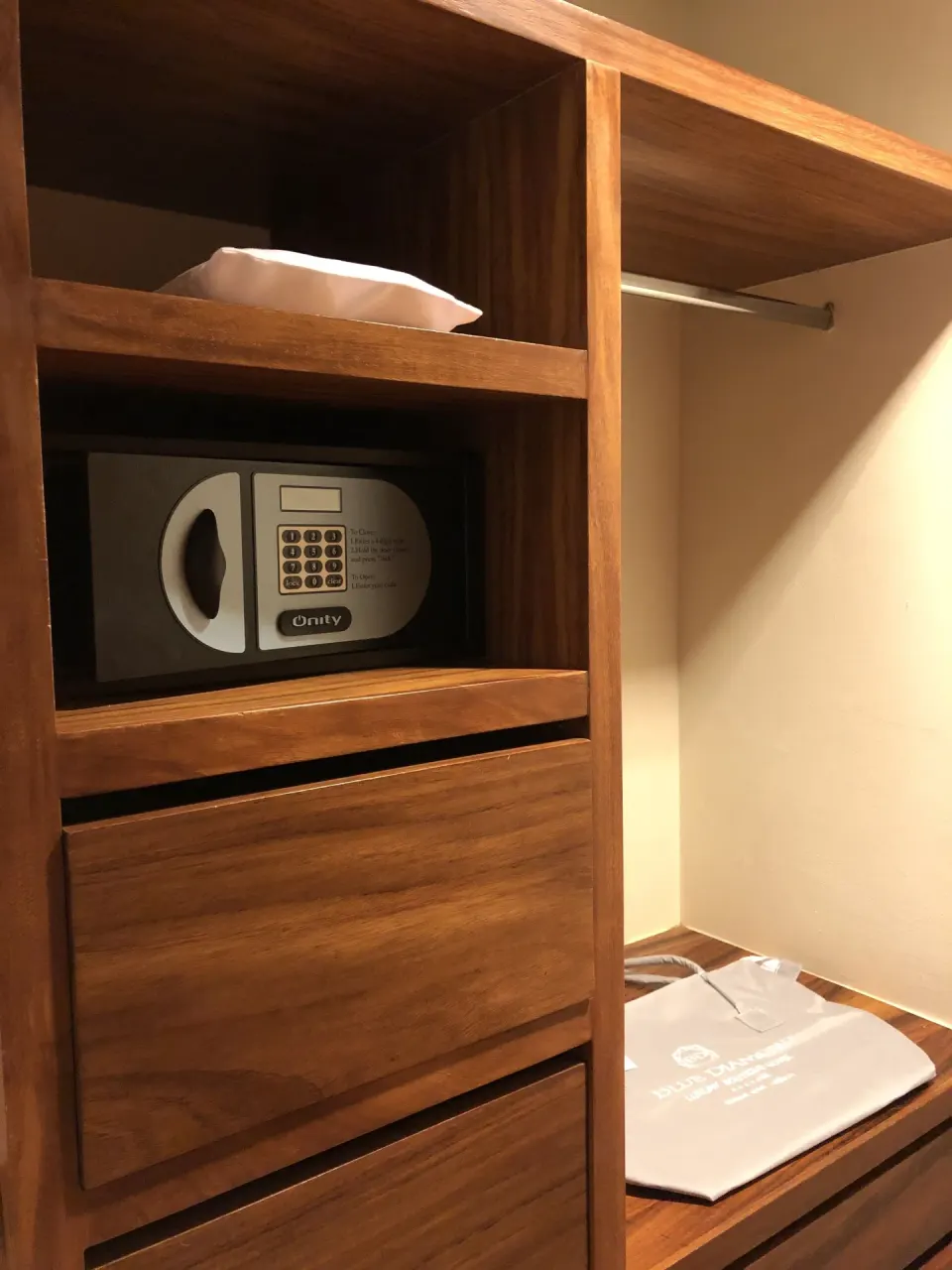 Wood closet with in-room safe in a Junior Suite Patio at Blue Diamond Luxury Boutique.