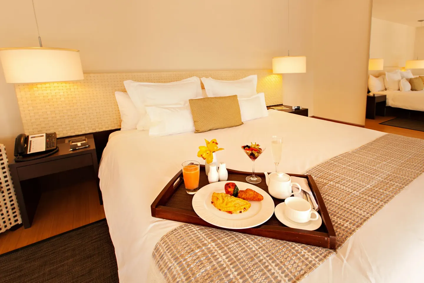 Junior Suite Patio king bed with breakfast tray at Blue Diamond Luxury Boutique.