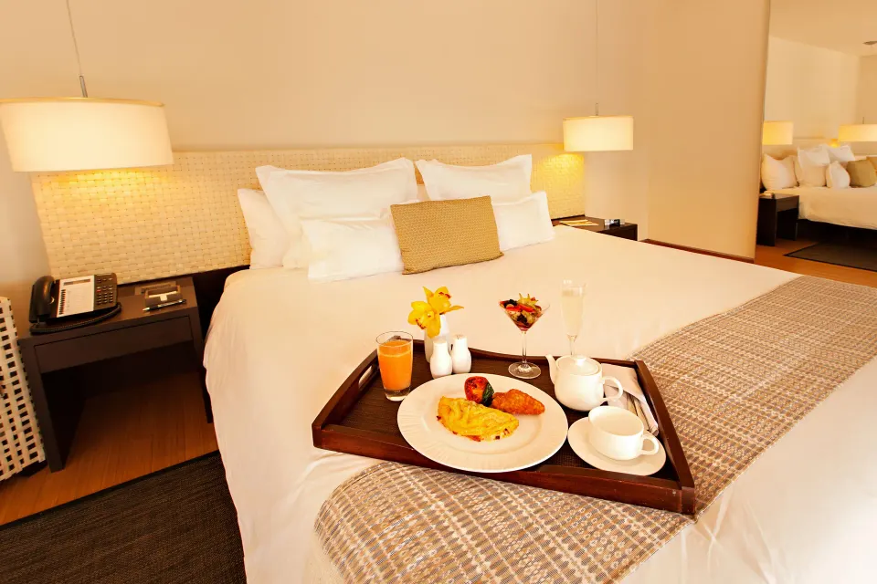 Junior Suite Patio king bed with breakfast tray at Blue Diamond Luxury Boutique.