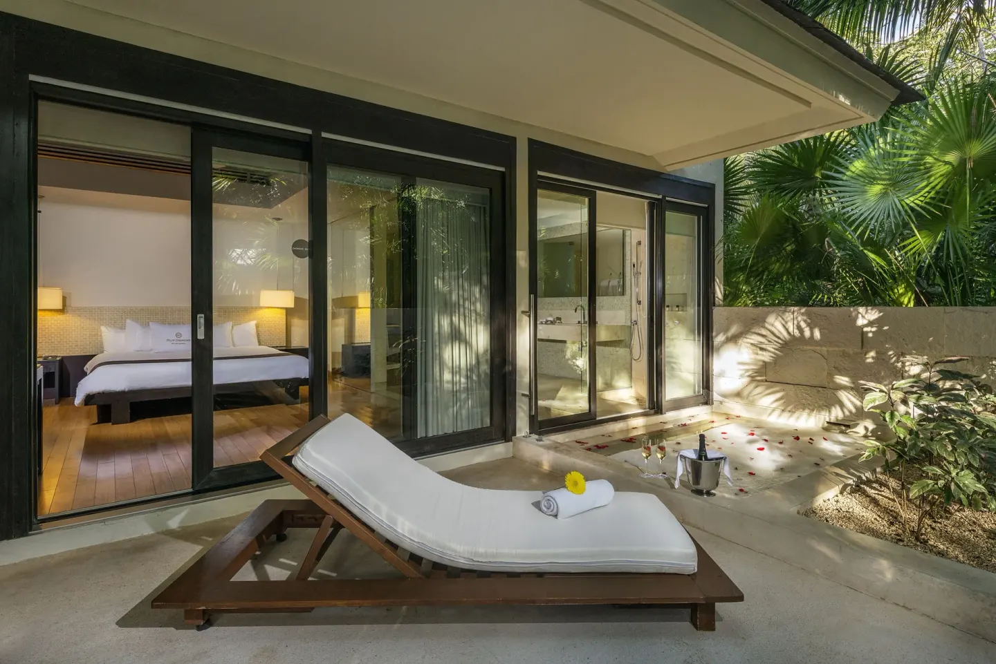 Junior Suite patio at Blue Diamond Luxury Boutique with a lounger outside glass bedroom doors.