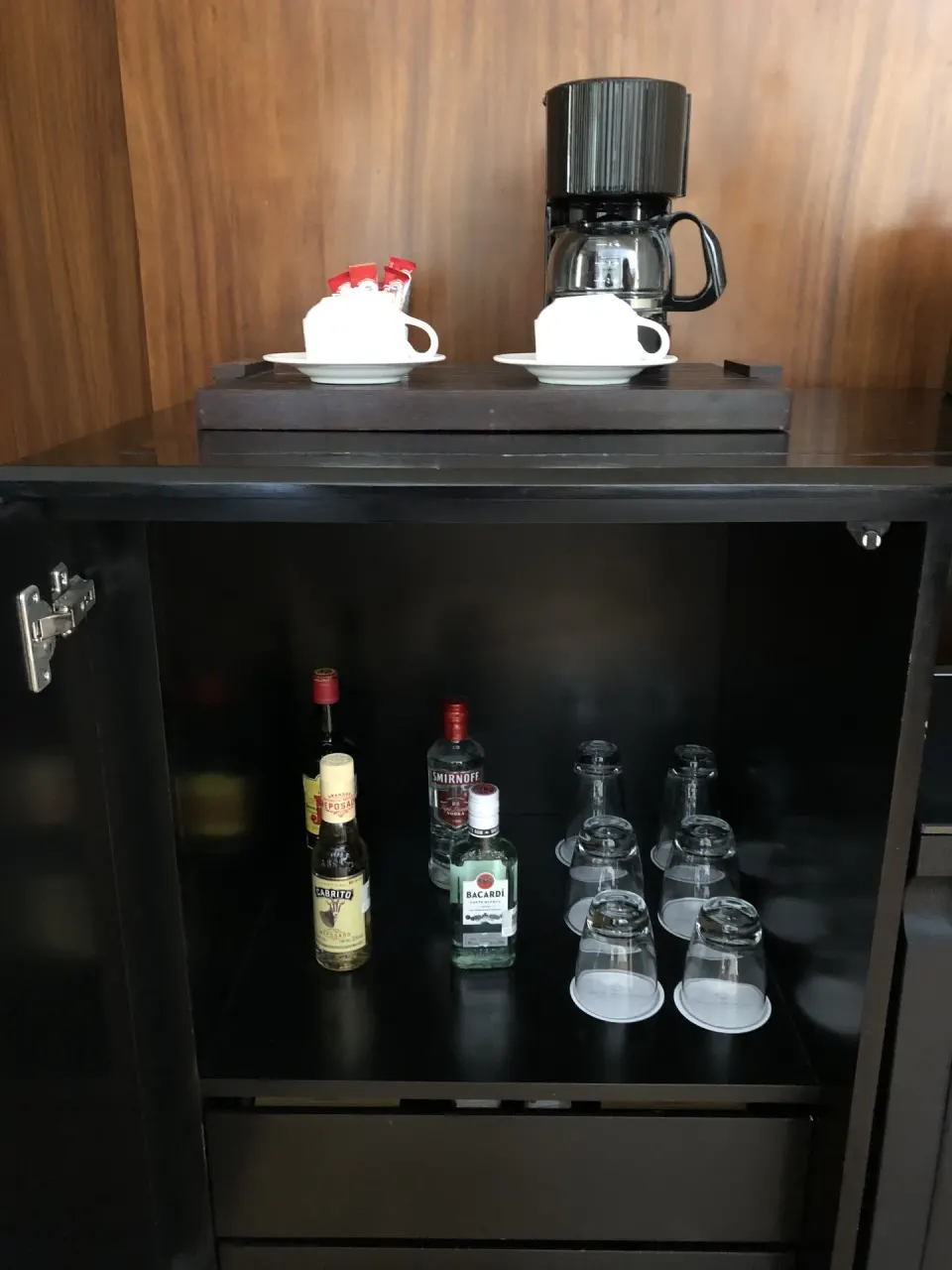 Patio Diamond Suite minibar cabinet with coffee maker and glassware at Blue Diamond Luxury Boutique.