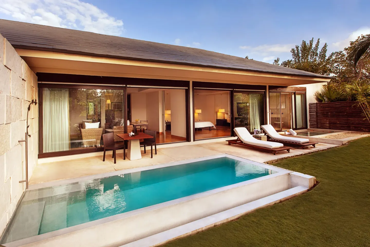 Patio Diamond Suite terrace with pool, loungers, and rooms behind glass at Blue Diamond Luxury Boutique.