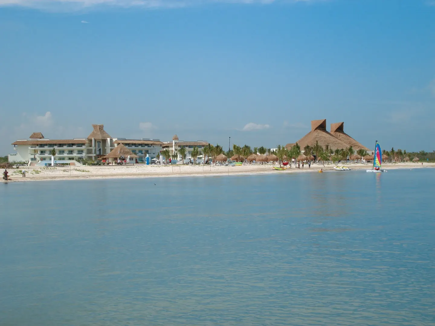 Beachfront resort buildings and calm water at BlueBay Grand Esmeralda.