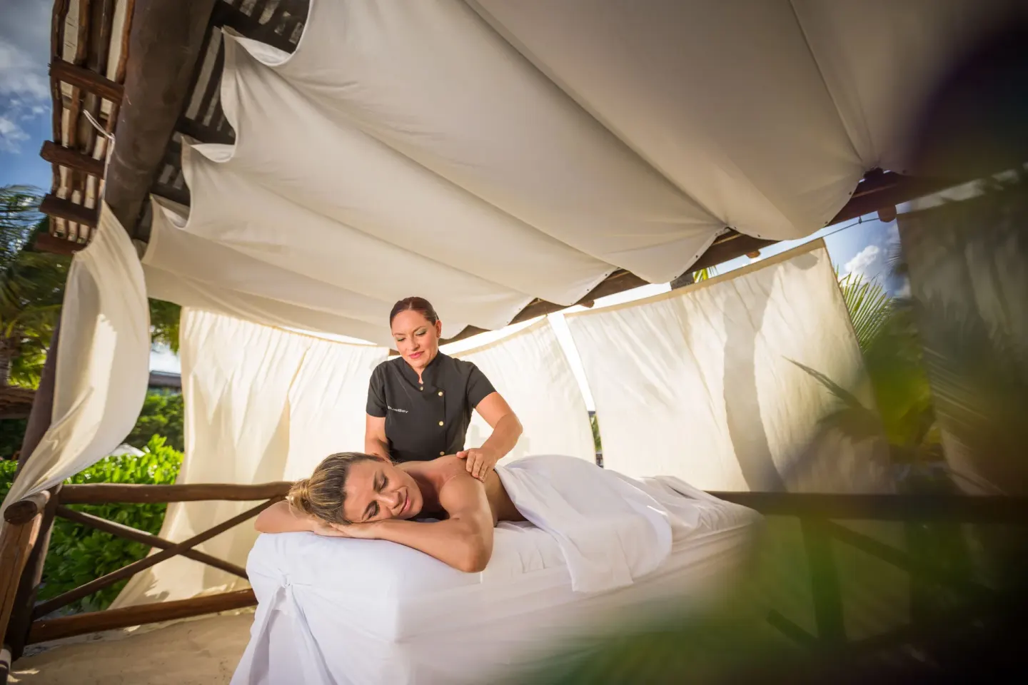 Outdoor massage under a white canopy at BlueBay Grand Esmeralda.