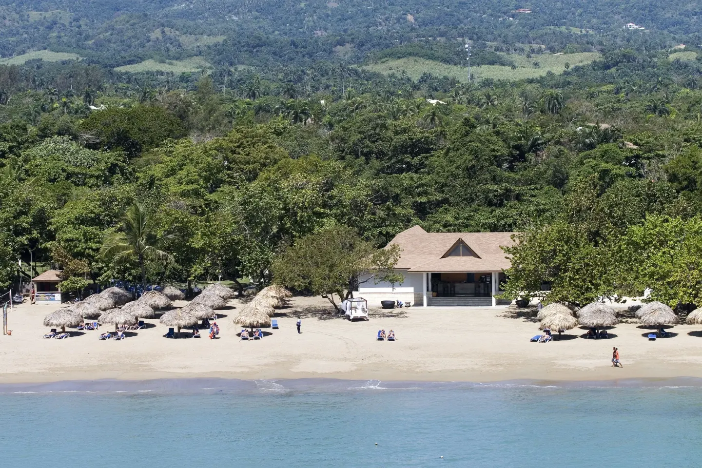 Aerial beachfront with palapas and turquoise water at BlueBay Villas Doradas.