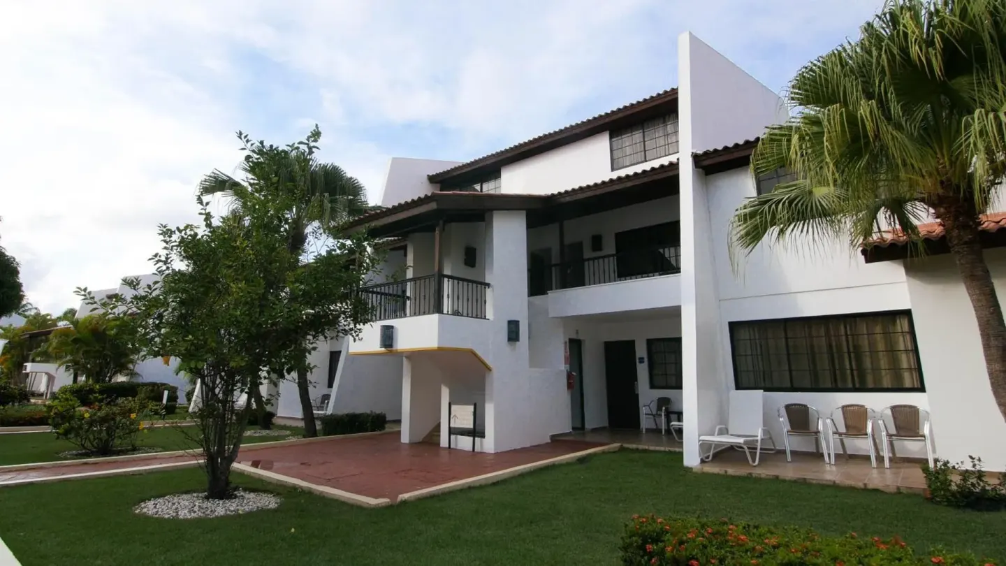 White guest buildings and lawn at BlueBay Villas Doradas.